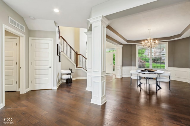 3744 Abney Point Dr, Carmel, IN 46077 - dining space featuring decorative columns, stairway, dark wood-style flooring, a chandelier, and wainscoting