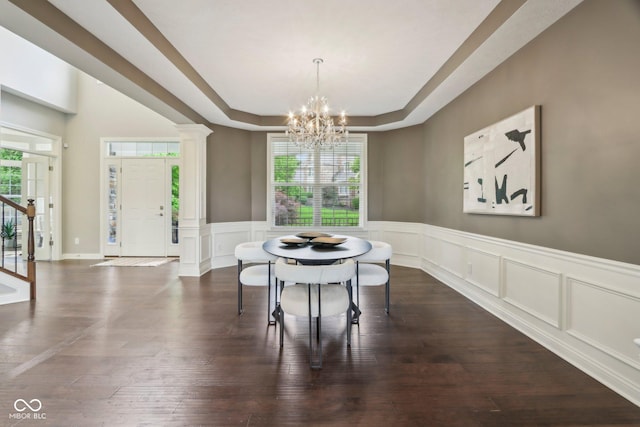 3744 Abney Point Dr, Carmel, IN 46077 - dining area featuring a chandelier, plenty of natural light, a raised ceiling, dark wood-style flooring, and wainscoting