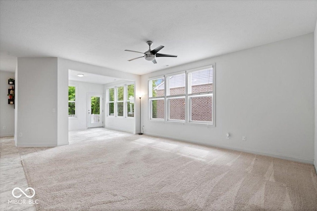 16573 Cava Dr, Fishers, IN 46037 - unfurnished living room with a ceiling fan, light carpet, and baseboards