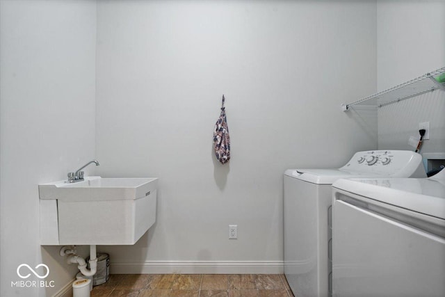 16573 Cava Dr, Fishers, IN 46037 - laundry room with washer and dryer and baseboards