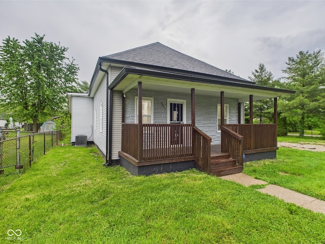 view of front of home featuring central AC unit, covered porch, and a shingled roof