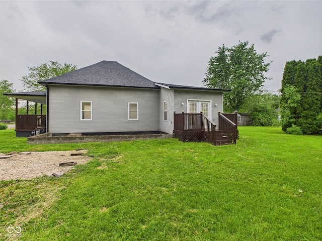 rear view of property with a lawn, a wooden deck, and french doors