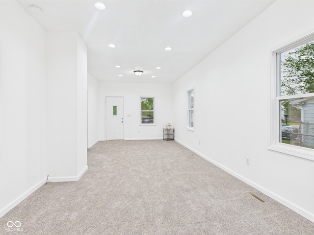 carpeted empty room featuring recessed lighting and baseboards
