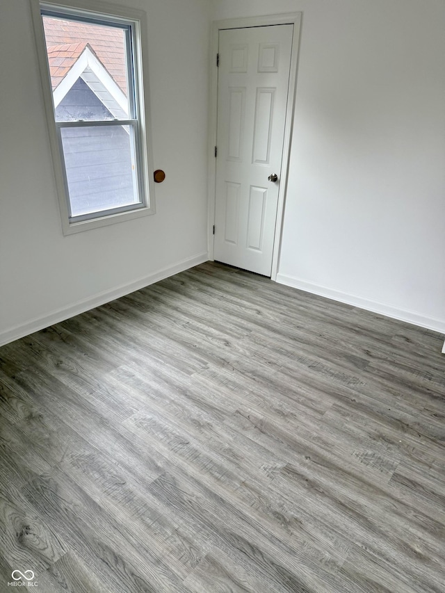 1322 S Belmont Ave, Indianapolis, IN 46221 - empty room with wood finished floors and baseboards