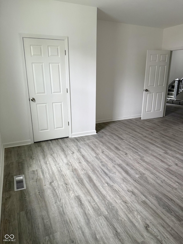 1322 S Belmont Ave, Indianapolis, IN 46221 - spare room featuring wood finished floors and baseboards