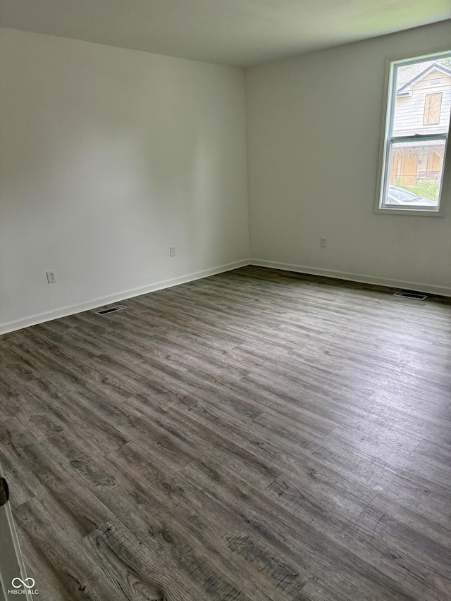 1322 S Belmont Ave, Indianapolis, IN 46221 - unfurnished room with dark wood-style floors and baseboards