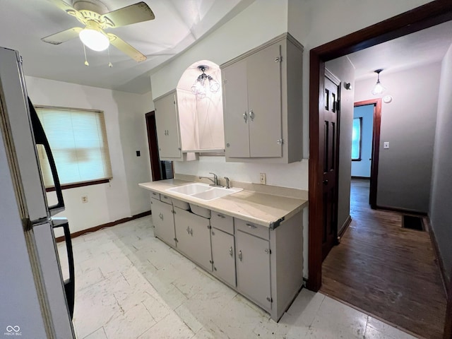 1714 Jefferson St, Anderson, IN 46016 - kitchen featuring a sink, freestanding refrigerator, gray cabinets, and baseboards