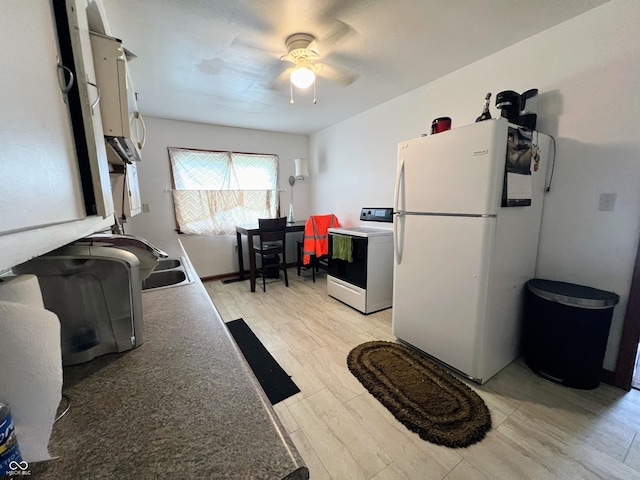 1714 Jefferson St, Anderson, IN 46016 - kitchen featuring electric stove, freestanding refrigerator, ceiling fan, a sink, and light wood-style floors