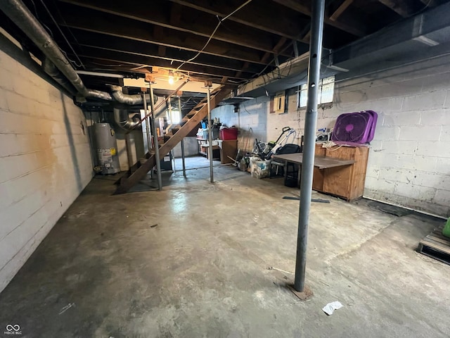 1714 Jefferson St, Anderson, IN 46016 - unfinished below grade area with gas water heater, concrete block wall, and stairway