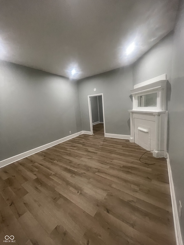 2116 Prospect St, Indianapolis, IN 46203 - unfurnished living room with wood finished floors and baseboards