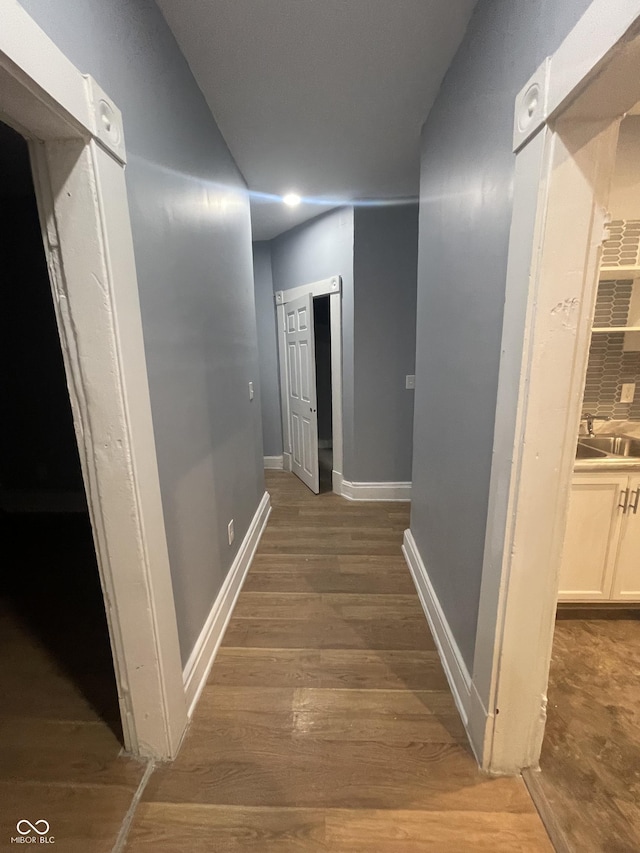 2116 Prospect St, Indianapolis, IN 46203 - hall featuring baseboards, wood finished floors, and a sink