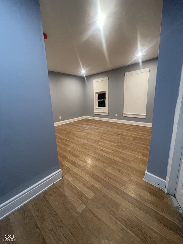 2116 Prospect St, Indianapolis, IN 46203 - unfurnished room with wood finished floors, baseboards, and a fireplace