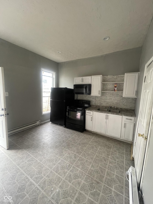 2116 Prospect St, Indianapolis, IN 46203 - kitchen featuring black appliances, a baseboard heating unit, white cabinetry, a sink, and a textured ceiling