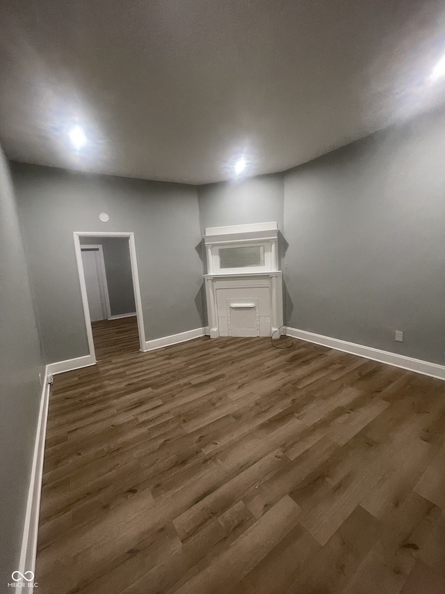 2116 Prospect St, Indianapolis, IN 46203 - unfurnished living room with baseboards and wood finished floors
