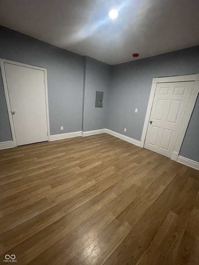 2116 Prospect St, Indianapolis, IN 46203 - unfurnished bedroom featuring wood finished floors and baseboards