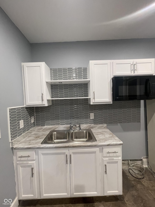 2116 Prospect St, Indianapolis, IN 46203 - kitchen featuring a sink, black microwave, white cabinets, and light countertops