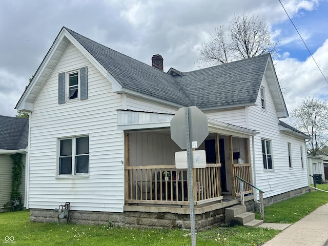 600 S Oak St, Fortville, IN 46040 - view of front facade with covered porch, a chimney, and roof with shingles