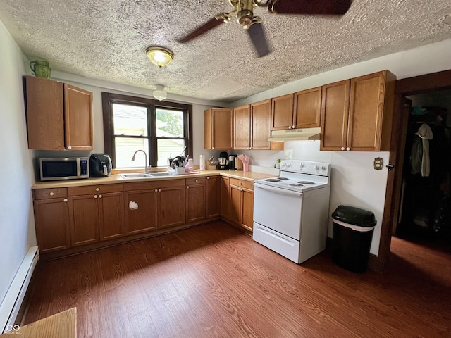 600 S Oak St, Fortville, IN 46040 - kitchen with electric range, stainless steel microwave, under cabinet range hood, a baseboard radiator, and a sink