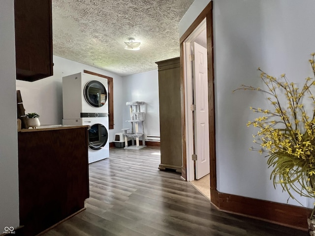 600 S Oak St, Fortville, IN 46040 - laundry room with stacked washing machine and dryer, wood finished floors, a textured ceiling, a baseboard heating unit, and baseboards