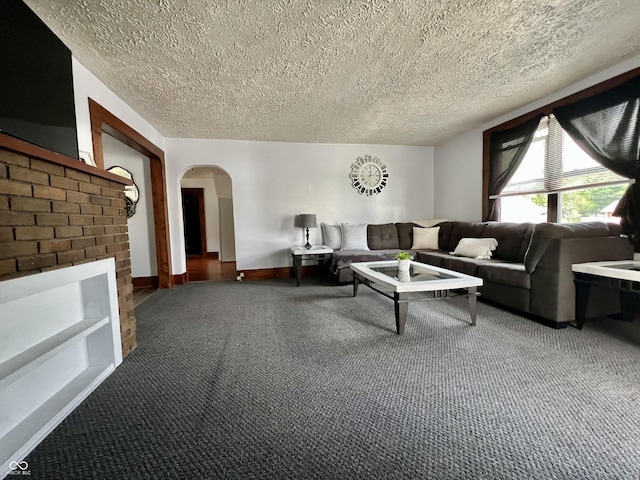 600 S Oak St, Fortville, IN 46040 - living area featuring carpet flooring, arched walkways, a textured ceiling, and baseboards