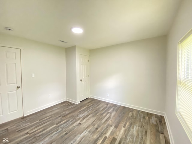 6150 E 25th St, Indianapolis, IN 46219 - empty room featuring dark wood-style flooring, baseboards, and a smoke detector
