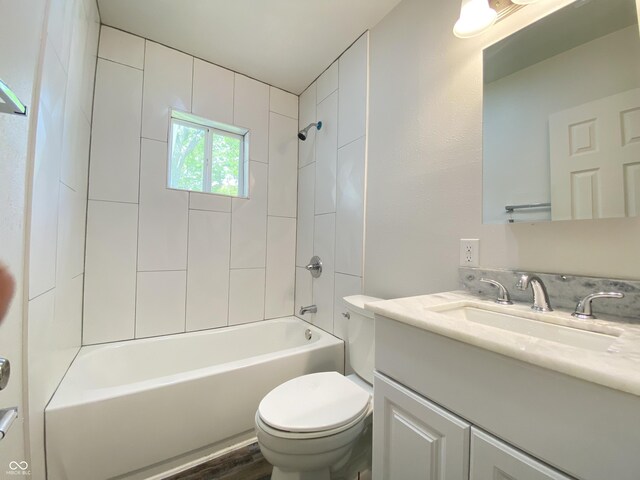 6150 E 25th St, Indianapolis, IN 46219 - bathroom featuring toilet, vanity, and bathing tub / shower combination