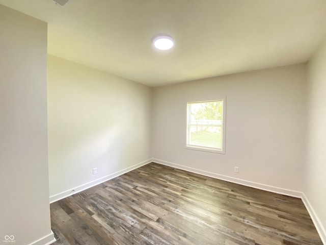 6150 E 25th St, Indianapolis, IN 46219 - spare room featuring dark wood finished floors and baseboards