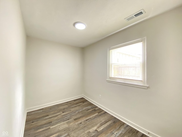 6150 E 25th St, Indianapolis, IN 46219 - unfurnished room with dark wood finished floors and baseboards