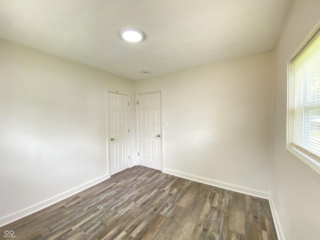 6150 E 25th St, Indianapolis, IN 46219 - unfurnished room with dark wood-style flooring and baseboards