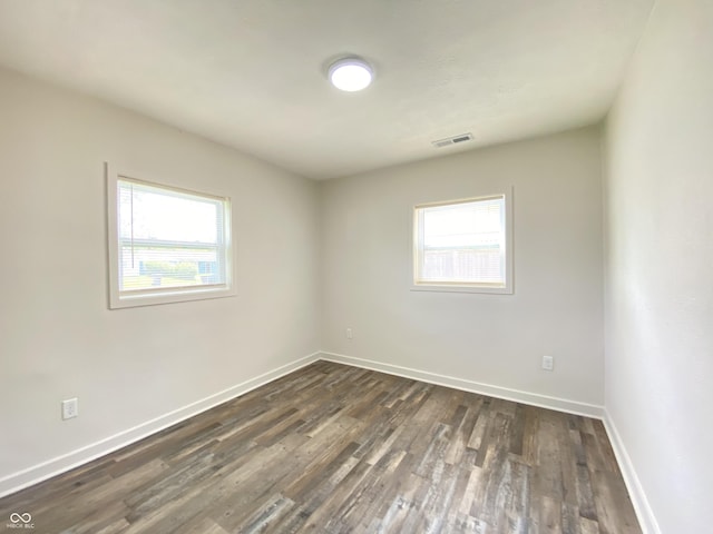6150 E 25th St, Indianapolis, IN 46219 - unfurnished room featuring plenty of natural light, dark wood-type flooring, and baseboards