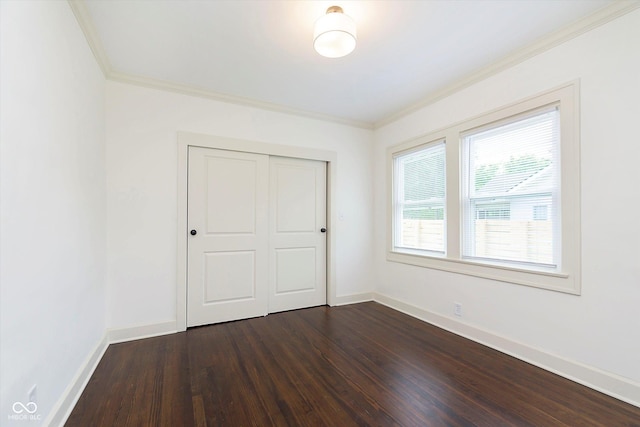 1502 Burdsal Pkwy, Indianapolis, IN 46208 - unfurnished bedroom with crown molding, dark wood-type flooring, a closet, and baseboards