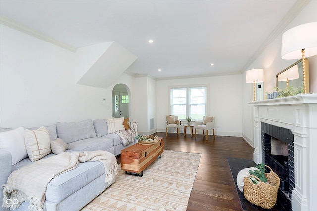 1502 Burdsal Pkwy, Indianapolis, IN 46208 - living room featuring ornamental molding, arched walkways, wood finished floors, a brick fireplace, and baseboards