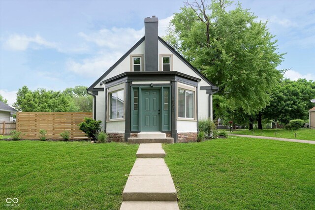 1502 Burdsal Pkwy, Indianapolis, IN 46208 - view of front of house with stucco siding and a chimney