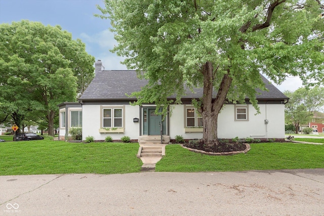 1502 Burdsal Pkwy, Indianapolis, IN 46208 - view of front of home featuring a shingled roof, stucco siding, a chimney, and a front lawn