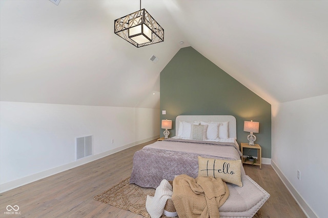 1502 Burdsal Pkwy, Indianapolis, IN 46208 - bedroom featuring wood finished floors, vaulted ceiling, and baseboards