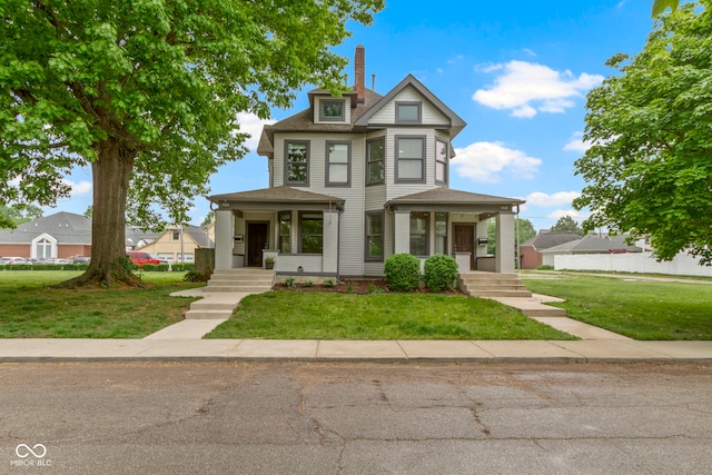 1526 Carrollton Ave, Indianapolis, IN 46202 - victorian-style house with a porch, a chimney, and a front yard