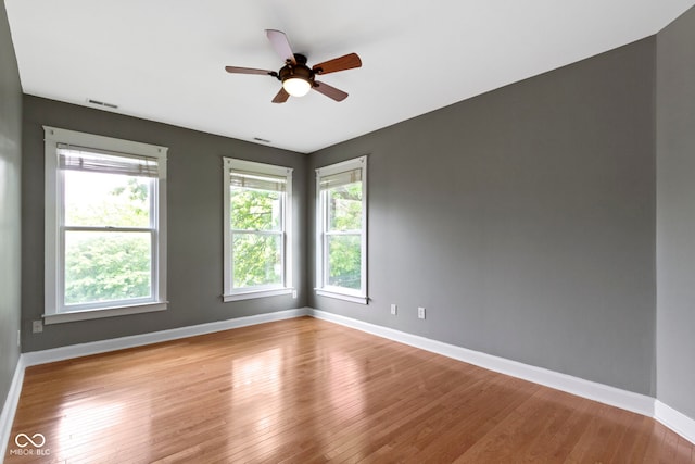 1526 Carrollton Ave, Indianapolis, IN 46202 - empty room with plenty of natural light, baseboards, and wood finished floors