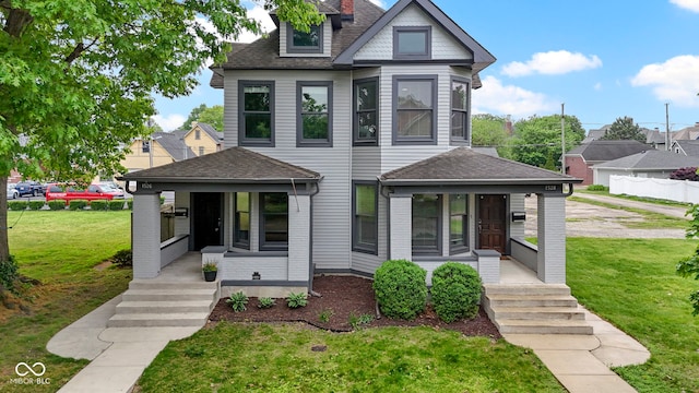 1526 Carrollton Ave, Indianapolis, IN 46202 - victorian home with a porch, a front lawn, and a shingled roof