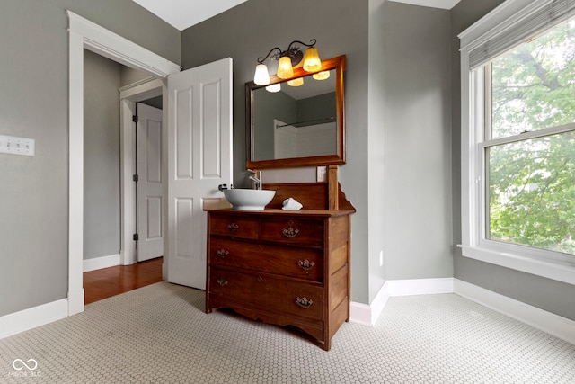 1526 Carrollton Ave, Indianapolis, IN 46202 - bathroom featuring plenty of natural light, vanity, and baseboards
