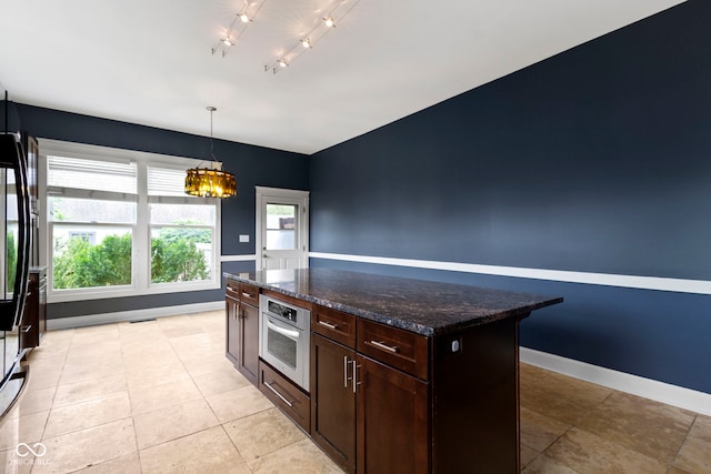 1526 Carrollton Ave, Indianapolis, IN 46202 - kitchen featuring oven, a chandelier, baseboards, decorative light fixtures, and dark brown cabinets