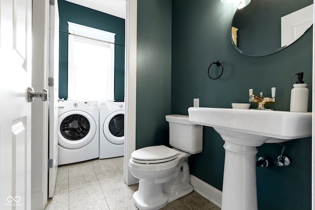 1526 Carrollton Ave, Indianapolis, IN 46202 - bathroom with washer and dryer, baseboards, and toilet