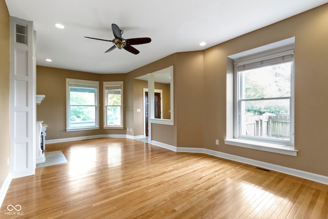 1526 Carrollton Ave, Indianapolis, IN 46202 - unfurnished living room featuring light wood-type flooring, plenty of natural light, a ceiling fan, baseboards, and recessed lighting