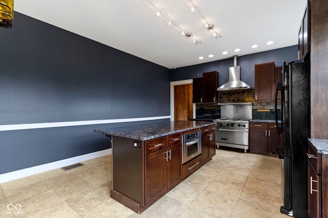 1526 Carrollton Ave, Indianapolis, IN 46202 - kitchen with wall chimney range hood, appliances with stainless steel finishes, decorative backsplash, a center island, and recessed lighting