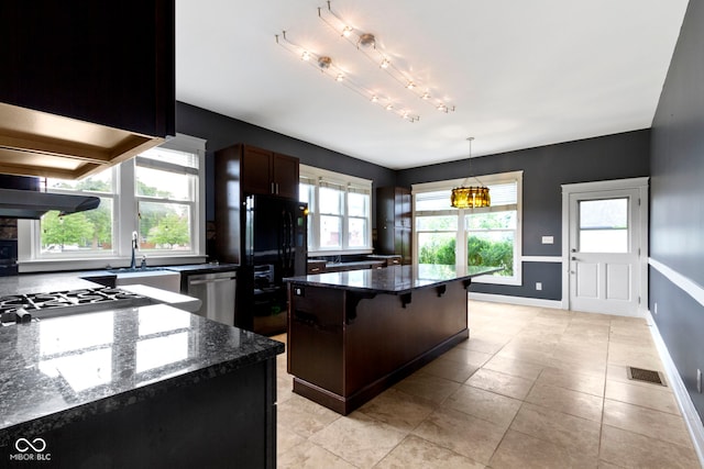 1526 Carrollton Ave, Indianapolis, IN 46202 - kitchen featuring stainless steel dishwasher, freestanding refrigerator, baseboards, and a kitchen island