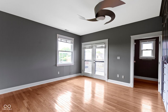 1526 Carrollton Ave, Indianapolis, IN 46202 - empty room with ceiling fan, light wood finished floors, and baseboards