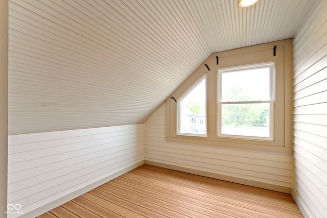1526 Carrollton Ave, Indianapolis, IN 46202 - additional living space with light wood-type flooring, lofted ceiling, wood walls, and wood ceiling