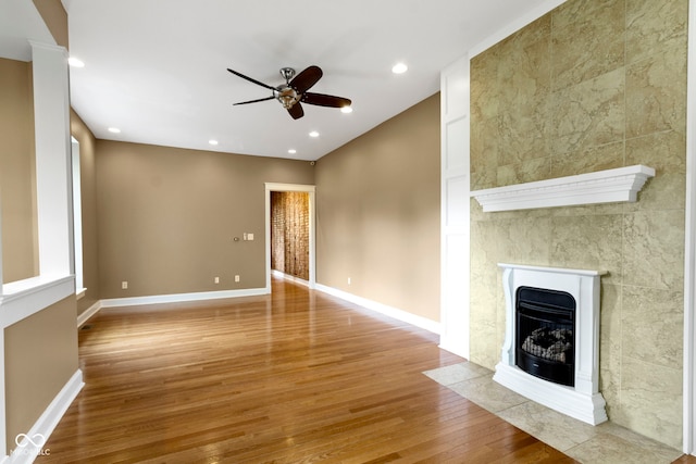 1526 Carrollton Ave, Indianapolis, IN 46202 - unfurnished living room with wood finished floors, a fireplace with flush hearth, a ceiling fan, baseboards, and recessed lighting