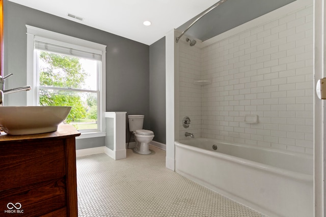 1526 Carrollton Ave, Indianapolis, IN 46202 - bathroom featuring toilet, a sink, bathtub / shower combination, and healthy amount of natural light