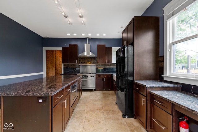 1526 Carrollton Ave, Indianapolis, IN 46202 - kitchen with appliances with stainless steel finishes, wall chimney exhaust hood, backsplash, a kitchen island, and dark stone counters