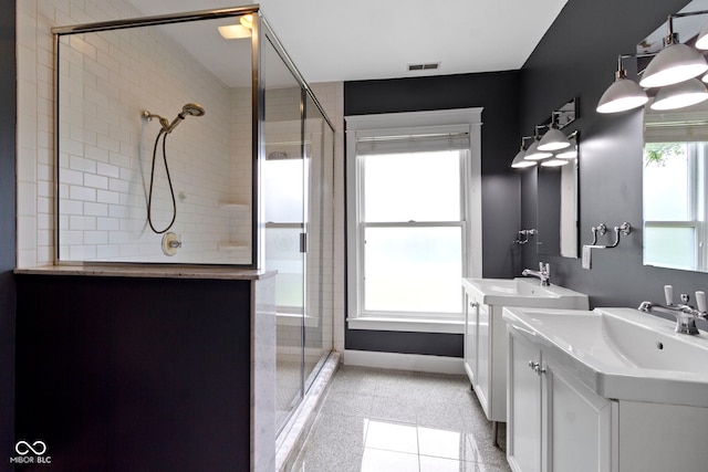 1526 Carrollton Ave, Indianapolis, IN 46202 - bathroom featuring a stall shower, baseboards, and two vanities